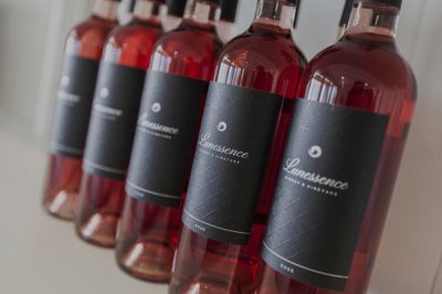 Fives bottles of rosé lined up with black labels