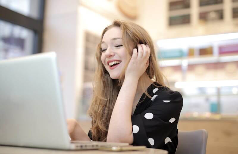 Woman smiling while using her laptop